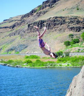 Anna Lau | Summer Arg Luke Shaw does a backflip off of the tallest cliff at Granite Point, a popular cliff diving and rock climbing destination on the Snake River 40 minutes Southwest of Pullman. The land is owned and maintained by the U.S. Army Corp of Engineers.