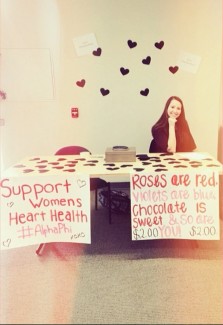 Allie Blakeman sits at a table in the Idaho Commons to raise money and awareness for women's heart health, the Alpha Phi Philanthropy.