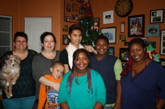 Jessy Forsmo-Shadid | Courtesy Jessy Forsmo-Shadid (far right) poses for a family photo with her family on Christmas 2013. Jessy was adopted by Christina Shadid (far left) and Michelle Forsmo (right of Shadid) on March 21, 2003.