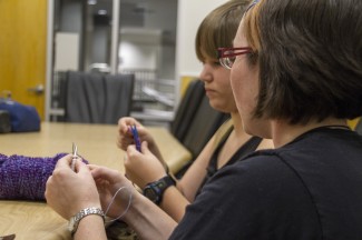 Cy Whitling | Rawr Rachel Foss, the president of Knitting Ninjas, helps Hannah LaPier with a project at the Ninjas' first meeting of the year.