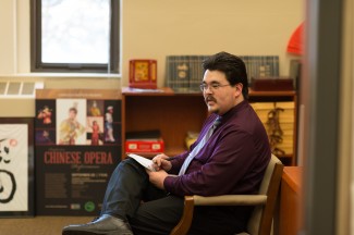 Philip Vukelich | Argonaut Dusty Fleener, administrative coordinator at the University of Idaho Confucius Institute, takes notes during an informal meeting in the institute office on the third floor of the Administration Building Thursday. The Confucius Institute's mission is to build Chinese language and culture in Idaho.