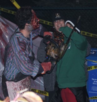 Ian Bartlett | Rawr Zombie chainsaw butchers and other bloody characters waited by the Tremors roller coaster for guests to come through before they revved their saws. When it came to scaring, they showed no mercy. However, to make sure everyone stayed safe, security guards were always nearby. Nov. 1 is the last day Scarywood is open this year.