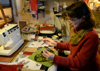 Amelia C. Warden | Rawr Tracy Randall, an artist at the Dahmen Barn, works on pot holders in her studio on Wednesday, Jan. 14, in Uniontown, WA.