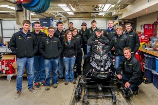 College of Engineering | Courtesy The College of Engineering Clean SnowMobile Team stands around its redesigned snowmobile.