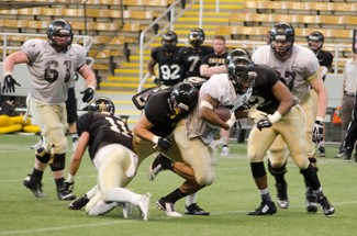Freshman linebacker Kaden Elliss tackles Senior running back Elijhaa Penny during Idaho's second scrimmage Saturday in the Kibbie Dome. Elliss led the Vandals in tackles for the second straight scrimmage. The defense outperformed the offense for much of the day.