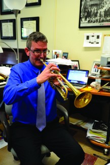 Amelia C. Warden | Rawr Music Professor Vern Sielert plays the trumpet in his office during a meeting with a student. Professor Sielert recently produced the jazz album Clarity with his band Unhinged Sextet.