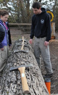 Amelia C. Warden | Rawr Tyler Herdman (right) explains the differences between various axes used for the axe throwing event to Kenzie Miner (left). The U of I Logger Sports Club competes in the Lumberjack Classic against other Pacific Northwest teams on Saturday, April 11.