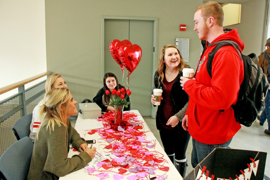 Yishan Chen | Argonaut Sophomores Sarah Medina, Nikaya Johnson and Alyssa Wilson sell rose-shaped chocolate to sophomores Kassy Kirby and Cody Lewis on the third floor of the Idaho Commons Thursday.