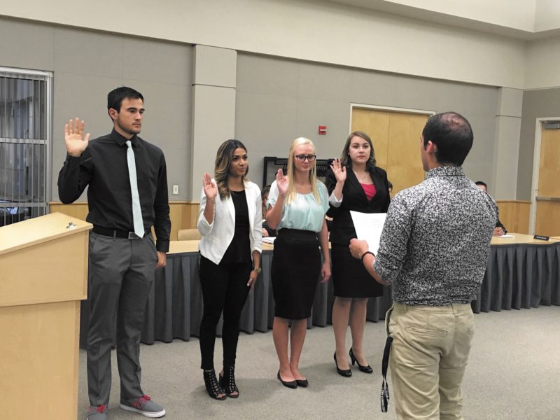 Taylor Nadauld | Argonaut Sophomore Michael Lejardi, junior Maria Meza, sophomore Lindsey LaPrath and senior Catherine Yenne are sworn into the ASUI Senate Wednesday night.
