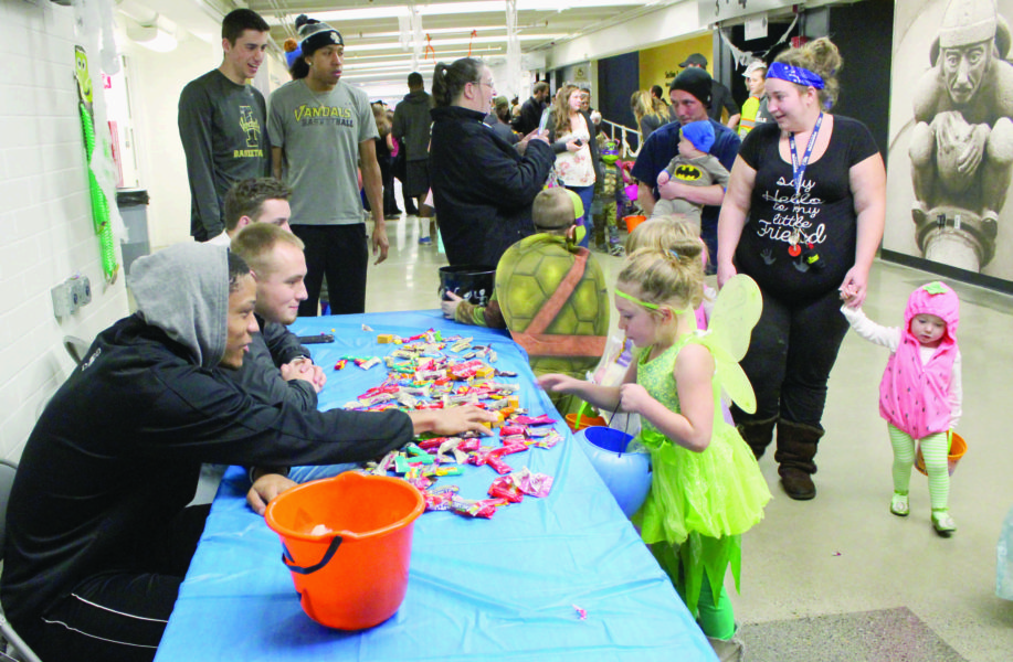 Diamond Koloski | Argonaut University of Idaho basketball players hand out candy to young trick-or-treaters during “Trick-or-Treat in the Dome” 5 p.m. Thursday in the Kibbie Dome.