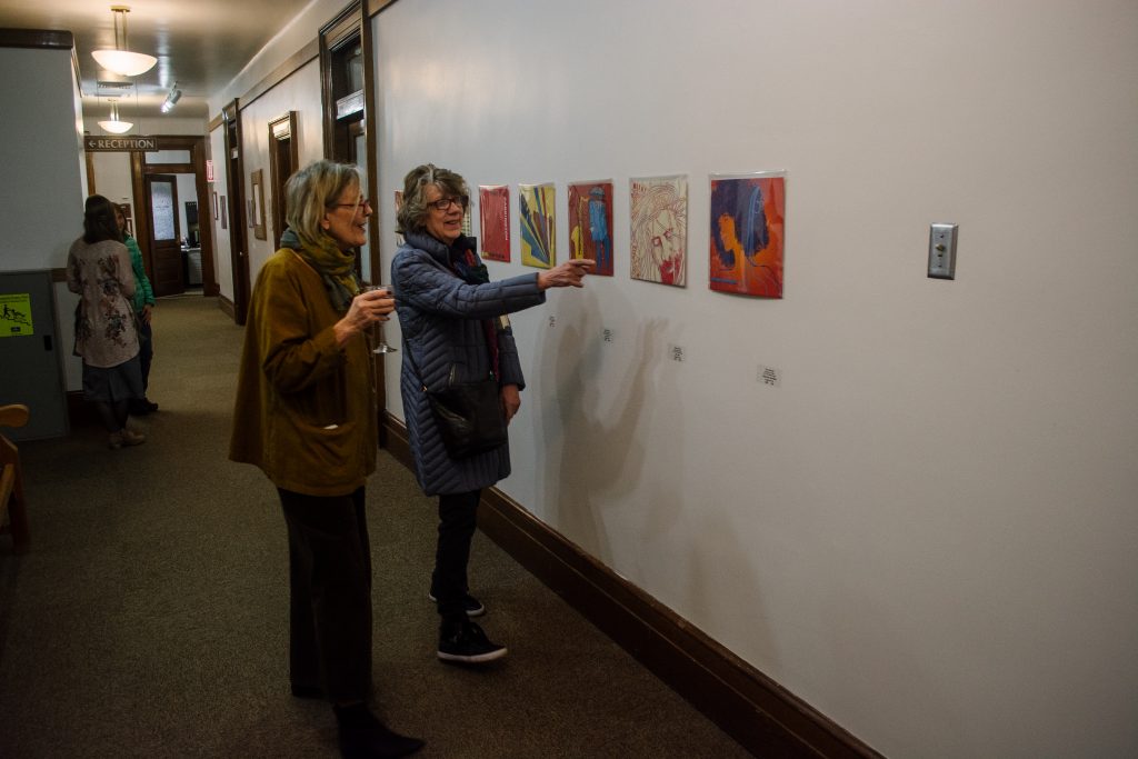 Members of the Moscow community enjoy the jazz-themed artwork by University of Idaho students.
