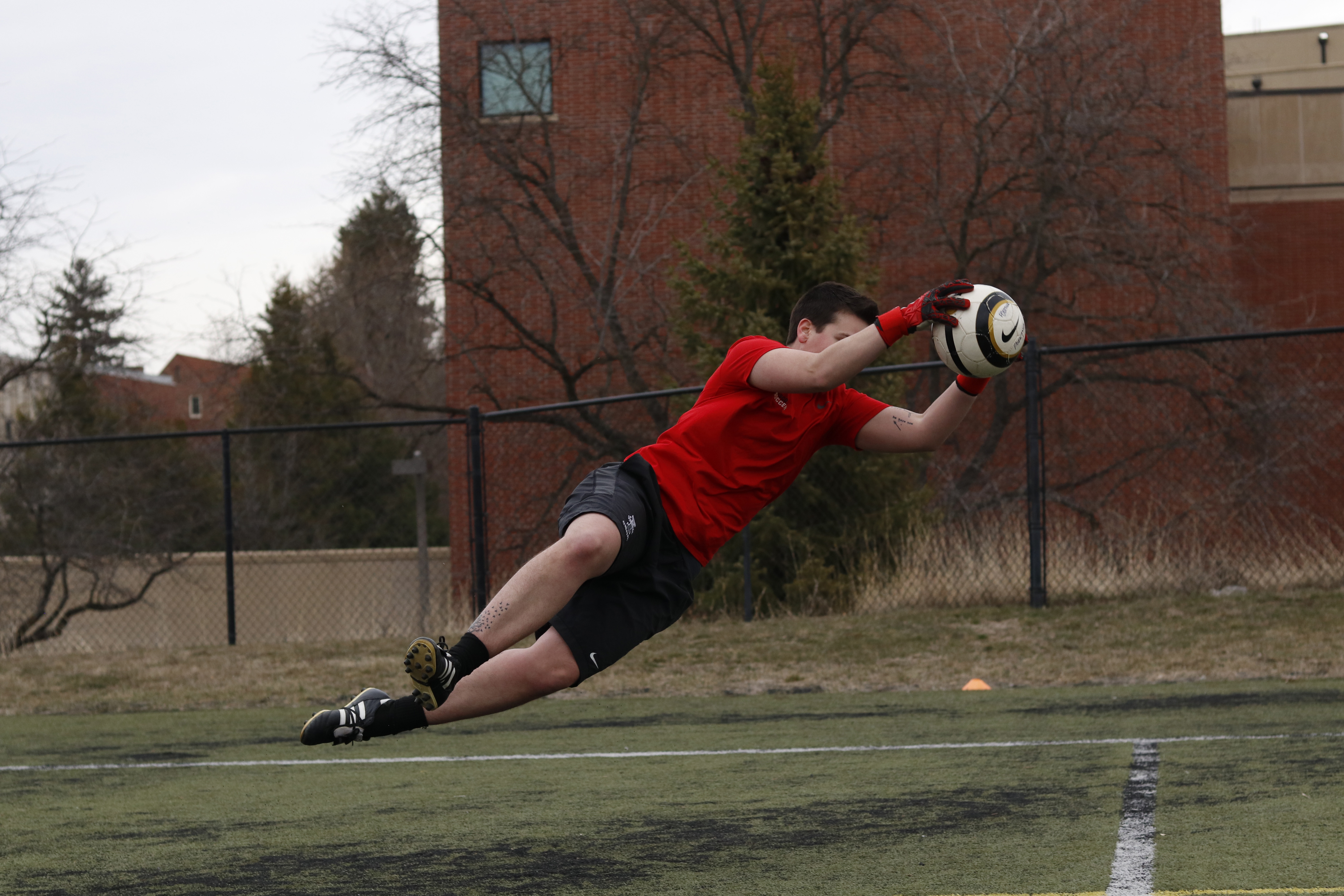 Carson Poertner dives for the ball on the Sprint Turf on Tuesday afternoon. Saydee Brass | Argonaut