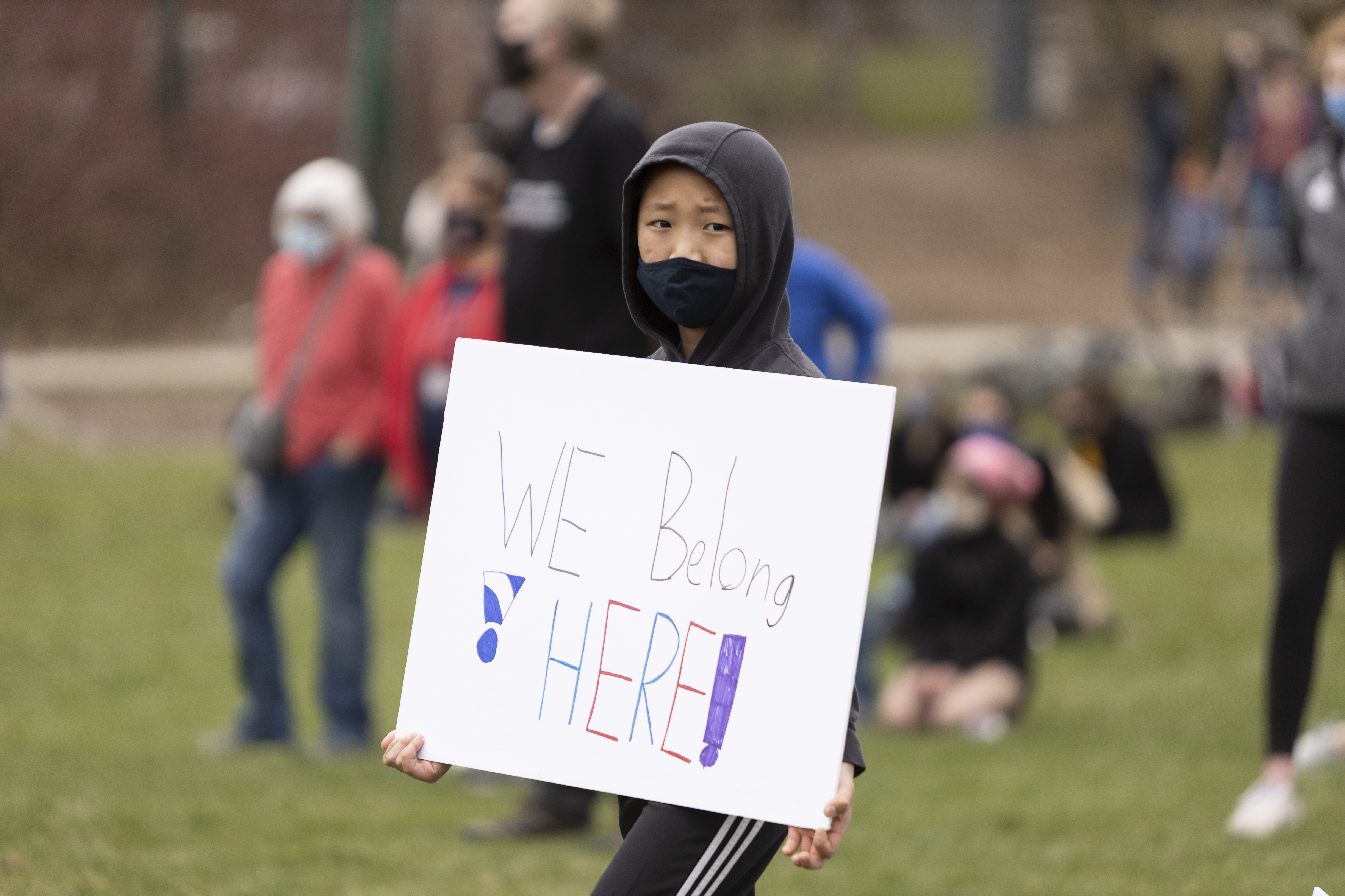 A child holds a sign that says "We belong here" at the stop AAPI hate on the Palouse rally in Pullman. Daniel Ramirez | The Argonaut 
