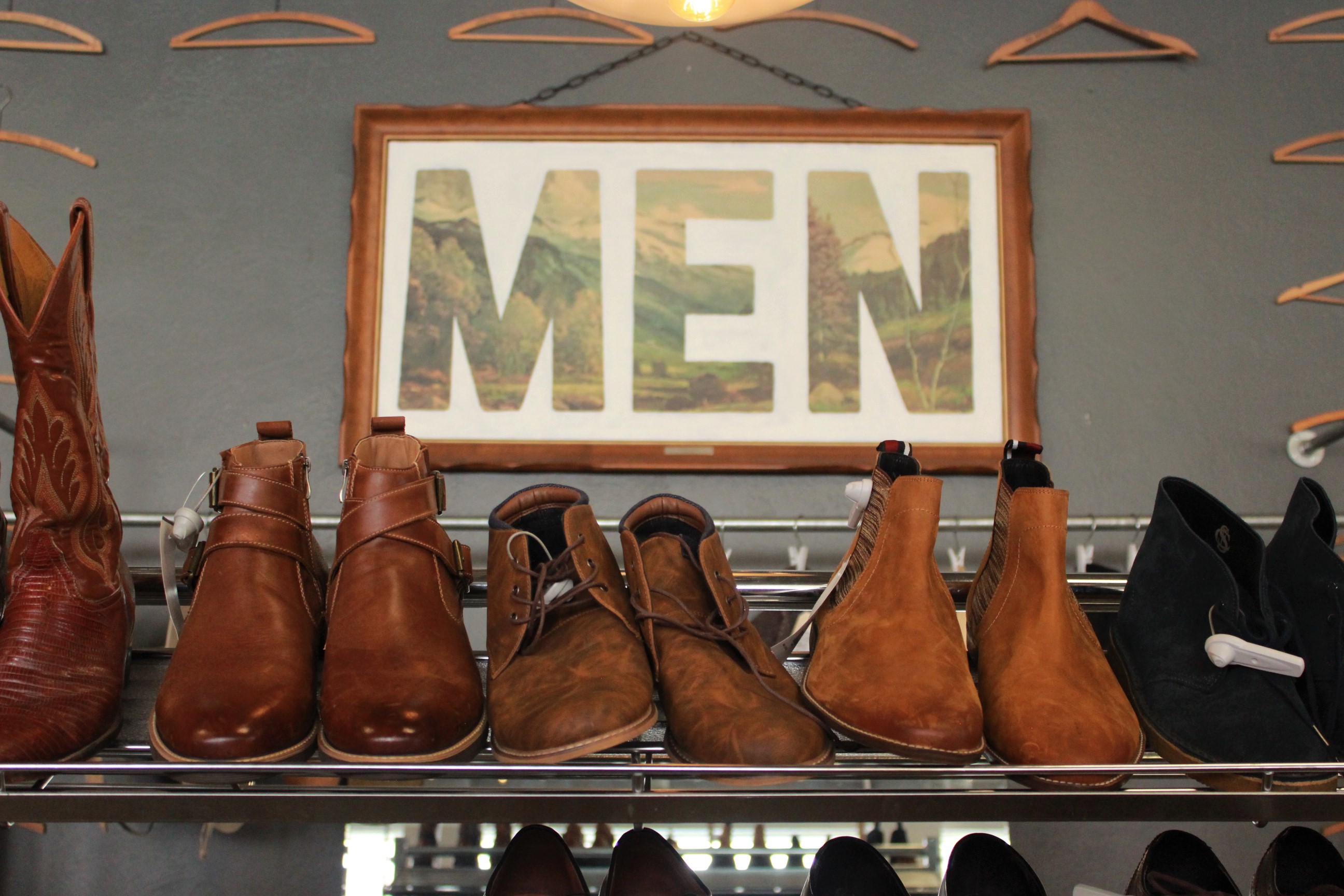 A men's show rack in front of the sign labeling the men's section in The Storm Cellar | Anteia McCollum | Argonaut