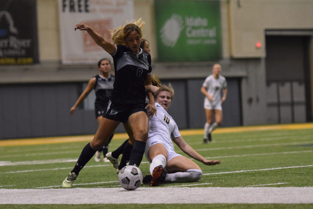 Idaho's freshman midfielder Leiden Huber slides to steal the ball from Hawaii's freshman forward Trini Quiroz on Sept. 8 in the Kibbie Dome | Saydee Brass | Argonaut