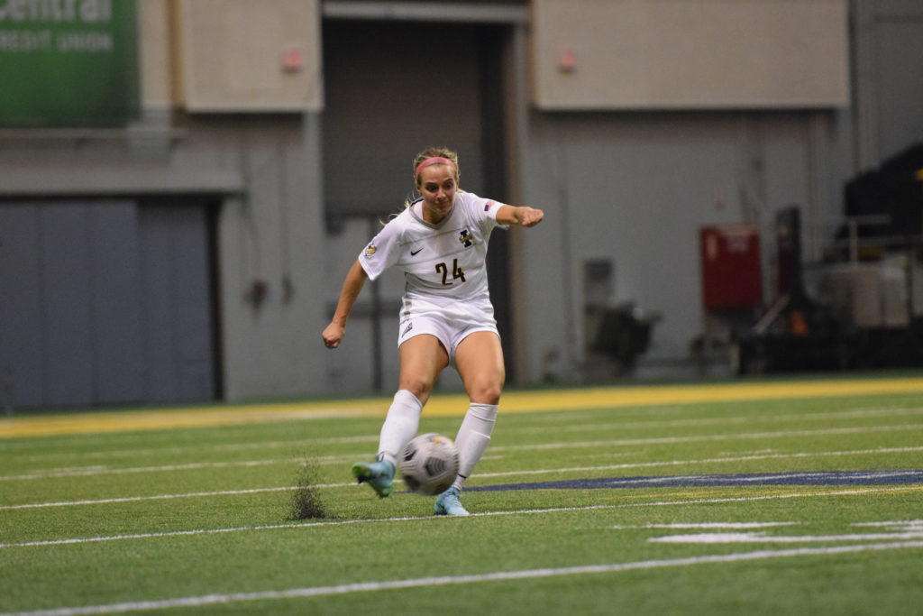 Redshirt junior midfielder Sidney Schmidt kicks the ball up the field as turf flies up from the Kibbie Dome during the University of Hawaii game on Sept. 8.  Saydee Brass | Argonaut