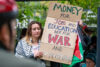 No Kings protester at Ghormley Park holds sign reading "money for jobs and education, not for war and deportation" | Colton Moore | Argonaut