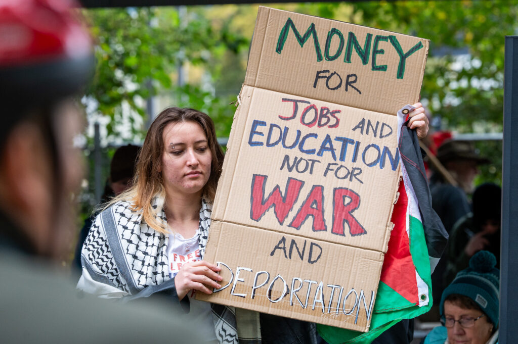 No Kings protester at Ghormley Park holds sign reading "money for jobs and education, not for war and deportation" | Colton Moore | Argonaut
